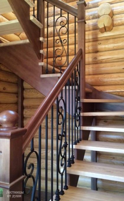 Ступени деревянной лестницы с кованными перилами