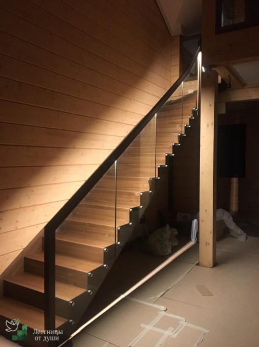 Деревянная лестница в доме со стеклянными ограждениями